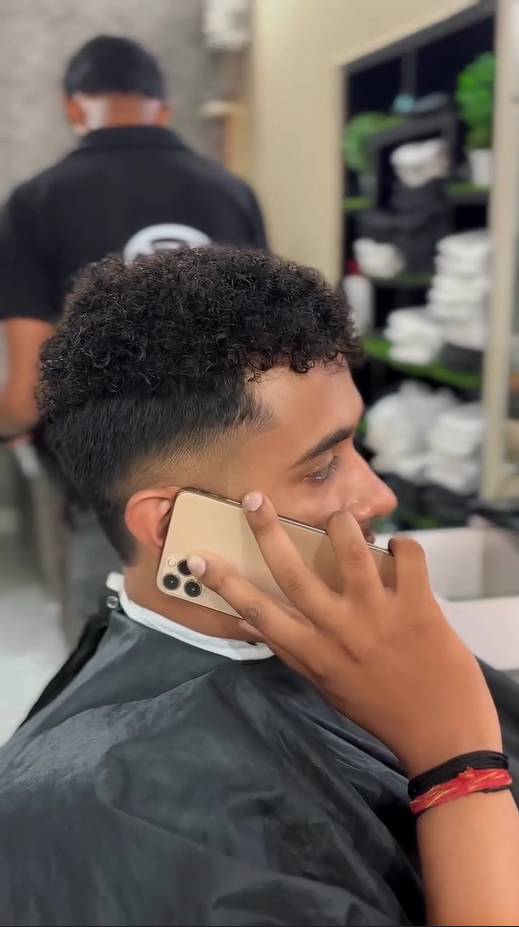 Curly Hair textured top with high skin fade and clean lineup – modern men’s haircut by CXI Salon Palwal, best men haircut near me Haryana